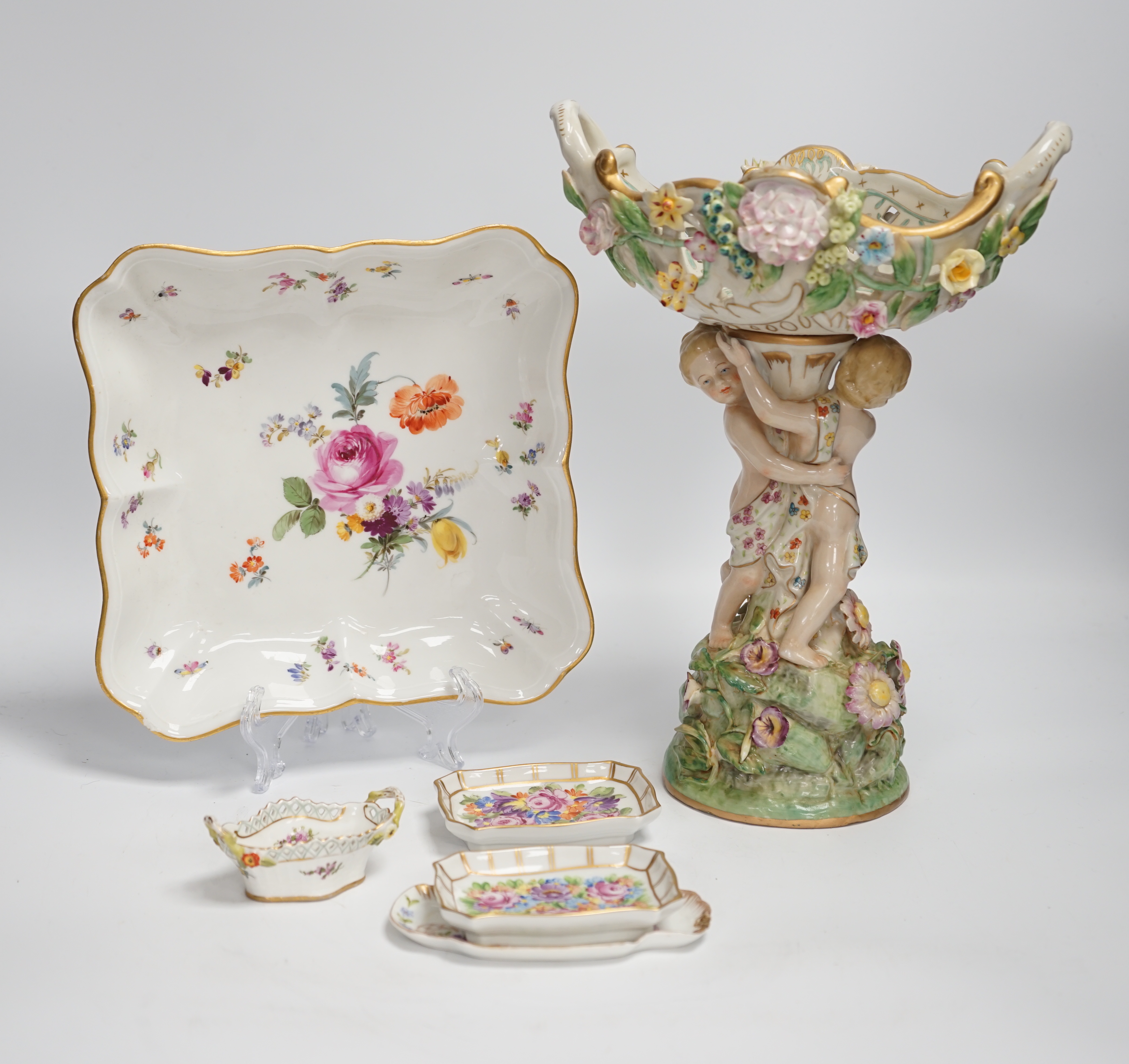 A German porcelain figural centrepiece, a Meissen floral dish, and various Dresden dishes, tallest 29cm